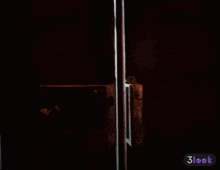 a man in a suit and tie is standing in a doorway with a 3look icon in the corner