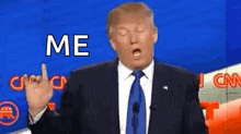 donald trump is making a funny face while giving a speech .