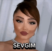 a woman wearing a bun and a necklace with the word sevgim on it