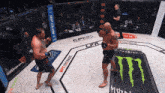 a man in a boxing ring with a monster energy can in the middle
