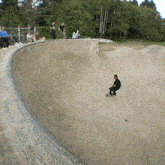 a man is riding a skateboard down a ramp in a skate park