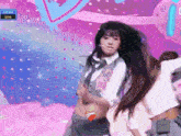 a girl with a heart tattoo on her stomach is dancing on a stage