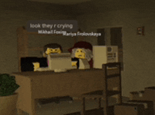 two lego figures sit at a desk with a sign that says " look they r crying "