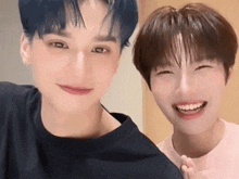 two young men are posing for a picture and smiling