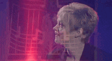 a woman with short hair is looking at the camera with a red light behind her