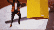 a man is jumping over a yellow box that says tesla