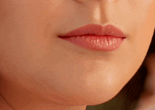 a close up of a woman 's lips with red lipstick