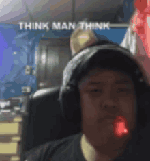 a man wearing headphones and a hat with the words think man think above him