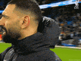 a man with a beard wearing a jacket with a hood