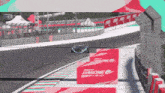 a race car is driving down a track with a sign that says turbone