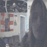 a poster on a wall that says gymano hangs above a woman 's face
