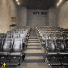 a row of empty seats in an auditorium with a sign on the wall that says ' q & o '