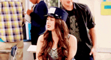 a girl wearing a police hat is sitting in a classroom next to a man