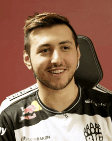 a man wearing a black and white shirt that says skinbaron