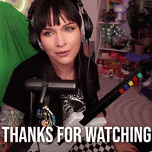 a woman wearing headphones and holding a controller with the words thanks for watching written below her