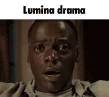 a close up of a man 's face with a surprised look on his face and the words lumina drama above him .