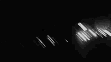 a blurry photo of a crowd of people dancing in a dark room