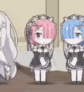 a group of three anime girls are standing next to each other .