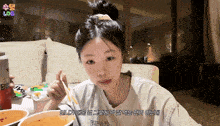 a woman sitting at a table with a bowl of food and a can of beer that says ' log ' on it