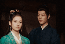 a man and a woman are standing next to each other and looking at each other