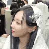a girl with blue hair wearing a white headband with a star and a heart on it