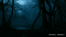 a man in a suit and tie is standing in a dark forest with the words minimaxel hailuo ai below him