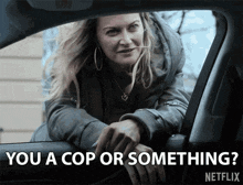 a woman leaning out of a car window with the words you a cop or something written below her