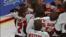 a group of hockey players are hugging each other and one of them has the name neutens on the back of his jersey