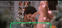 a man and a woman are kissing each other 's hands in a room .