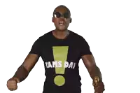 a man wearing a yams day shirt holds a bottle in his hand