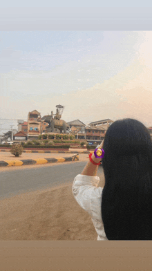 a woman is looking at a statue of an elephant