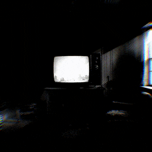 a black and white photo of a room with a television
