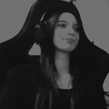 a woman is giving the middle finger while wearing headphones