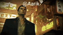 a man in a suit is standing in front of a sign that says aarik