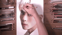 a person is drawing a picture of a man 's face with a pencil that says prismacolor