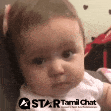 a baby with a star tamil chat logo on the bottom right