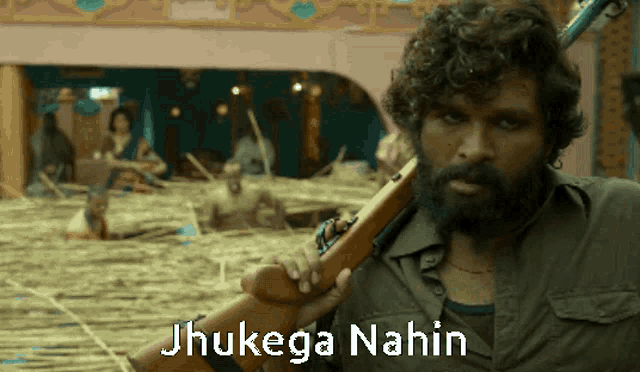 a man with a beard is holding a gun with the words jhulega nahin on the bottom