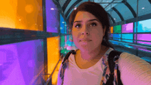 a woman taking a selfie in front of a stained glass wall