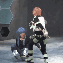 a man in a blue wig is kneeling down next to a man in a white shirt with the letter n on the back