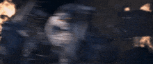 a blurred image of a person standing in front of flames