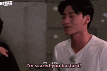a man in a white shirt is saying i 'm scared you bastard .
