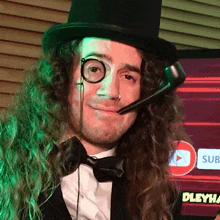 a man with long curly hair wearing a top hat and a microphone