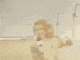 a blurred image of a woman talking on a cell phone with a man in the background