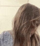 a close up of a woman 's hair with ear buds in her ears .