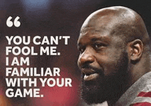 a bald man with a beard is standing in front of a quote from a basketball player .