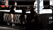 two women wrestling in front of a banner that says stardom #stardom