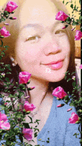 a woman is surrounded by pink roses and leaves
