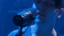 a woman sings into a microphone while a man plays a guitar