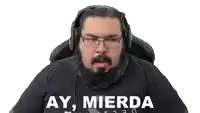 a man with a beard and glasses is wearing headphones and a shirt that says ay mierda