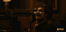 a man in a dark room with a netflix logo